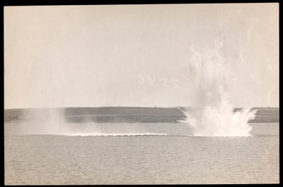 View of an underwater explosion, with water rising out of the surface, during the construction of the Panama Canal, 1913 by Byron Company